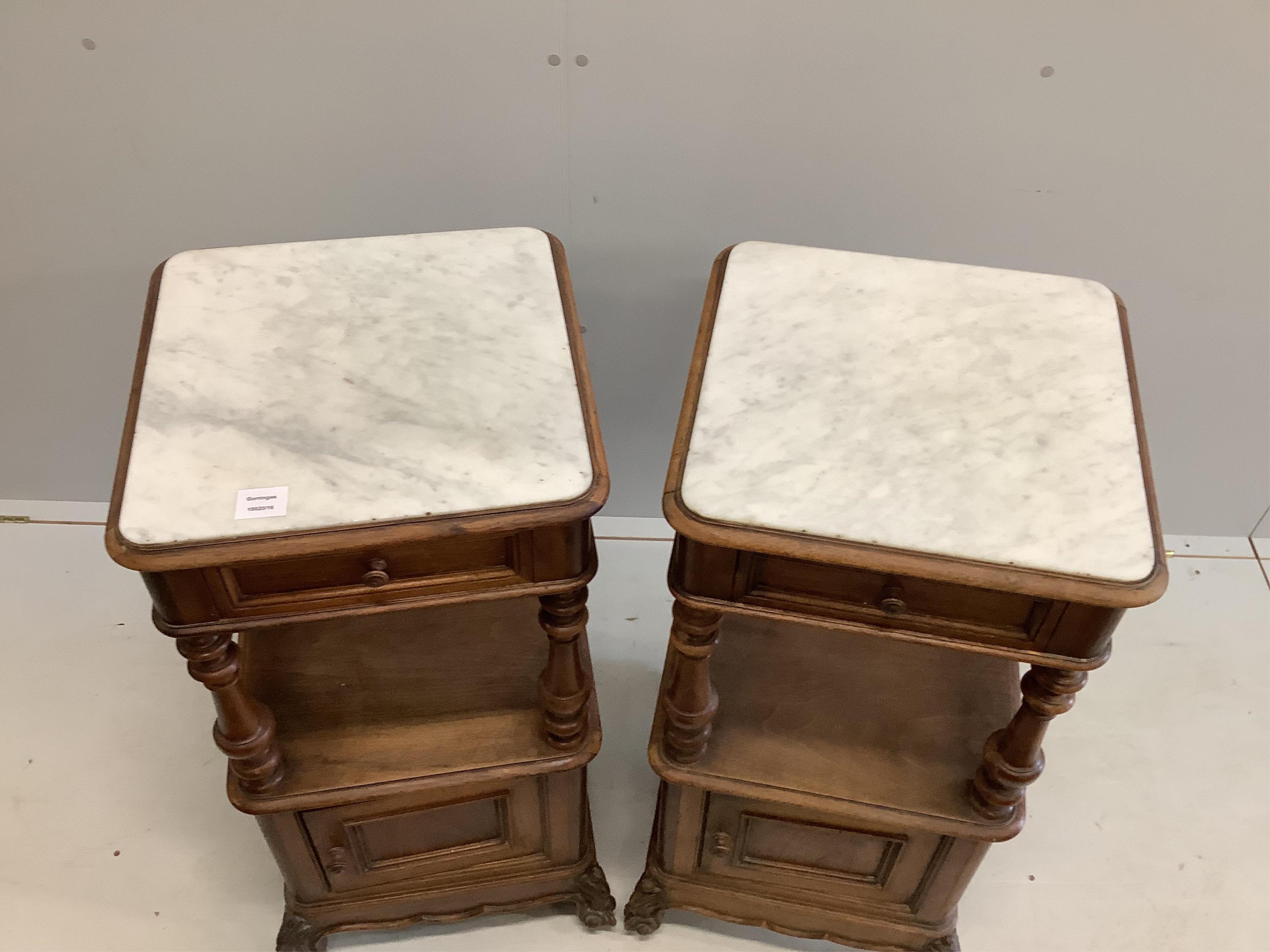 A pair of late 19th / early 20th century French marble top walnut two tier bedside cabinets, width 41cm, depth 41cm, height 89cm. Condition - fair